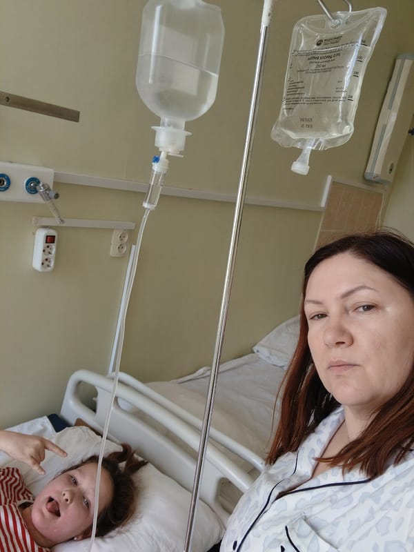 Woman receives IV treatment in hospital bed