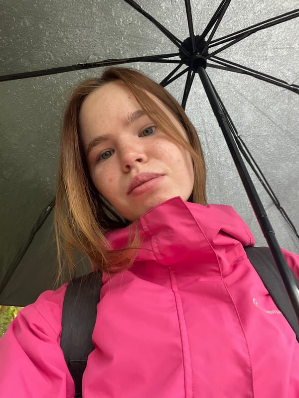Rainy morning moments captured in Chaikovsky: woman, cat, flower, fountain