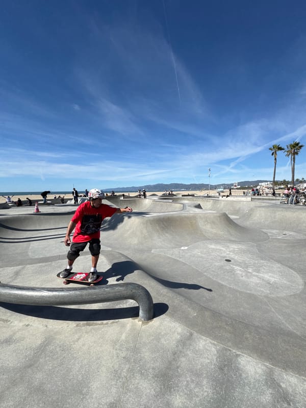 Skateboarder performs rail trick at beachside Los Angeles skatepark