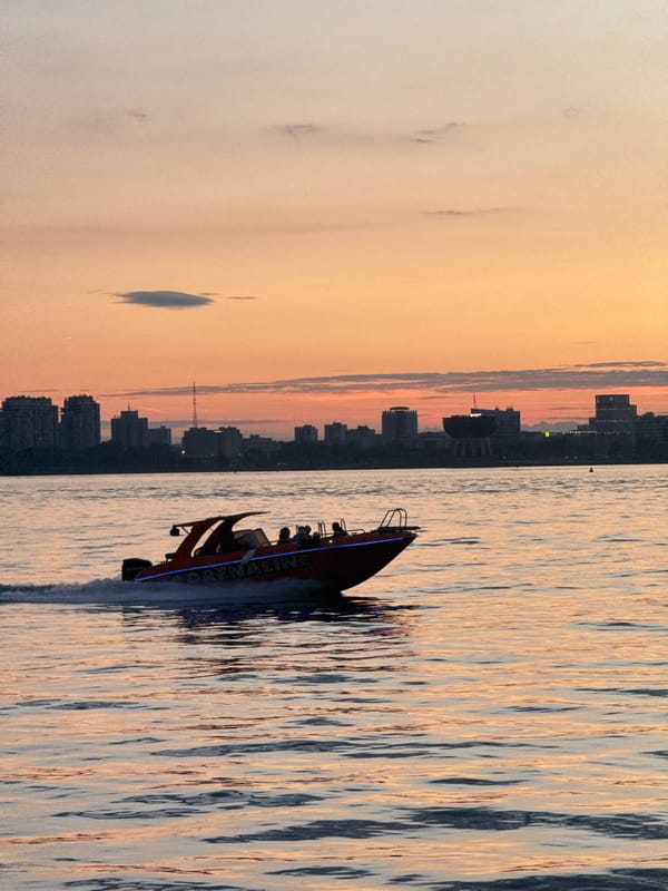 Speedboat cuts through Kazan's river at golden hour