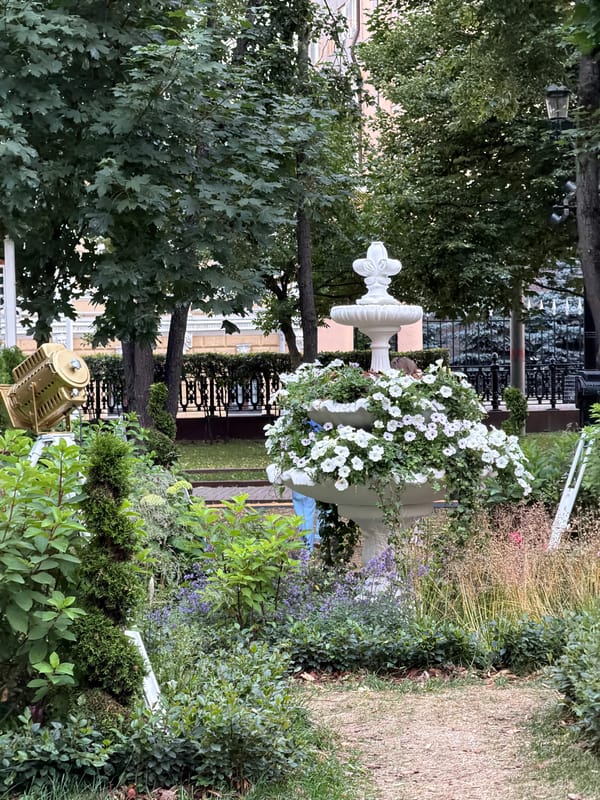 Moscow street life, park dogs, and ornate architecture on a summer afternoon