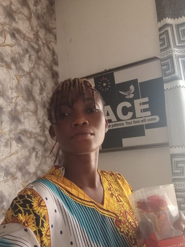 Woman with braided hair poses with roses in indoor setting