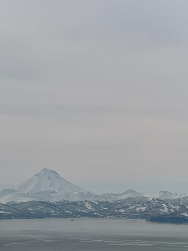 Snow-capped mountain landscape photographed with water foreground
