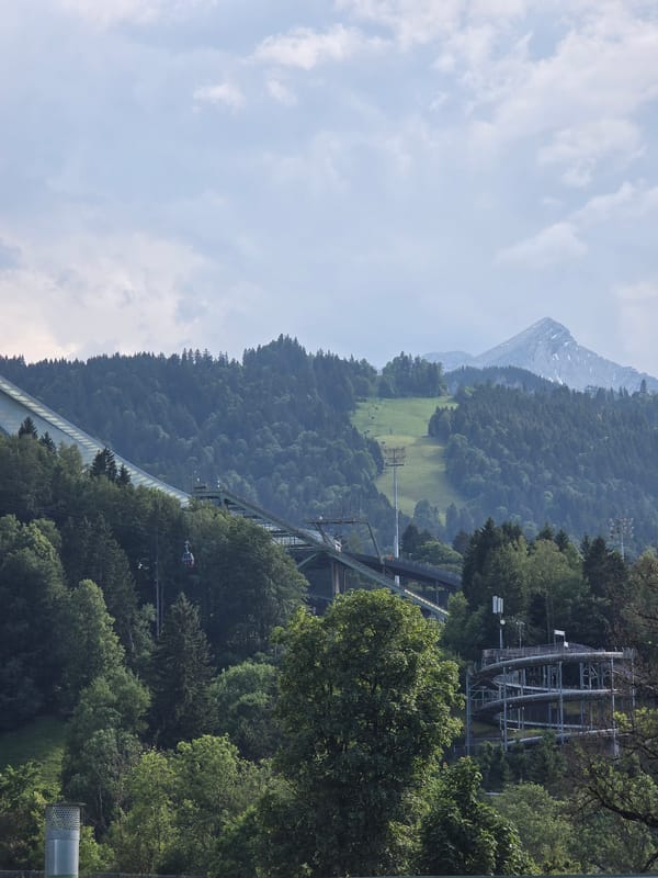 Packed summer day at Garmisch's outdoor pool beneath the Alps