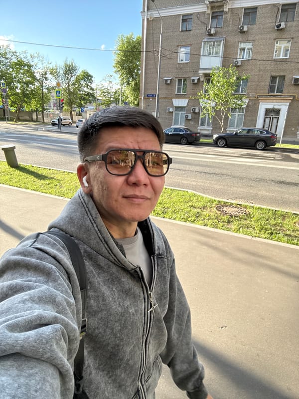Street selfie in Moscow, sunglasses and earbuds on.