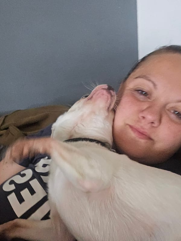 Woman photographed with small dog in Hem, France