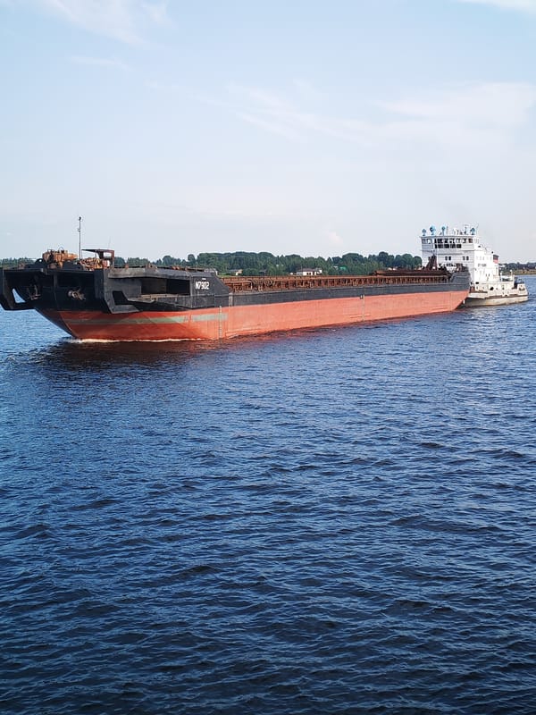 Tugboat pushes barge N7902 along the Volga near Beregovoy