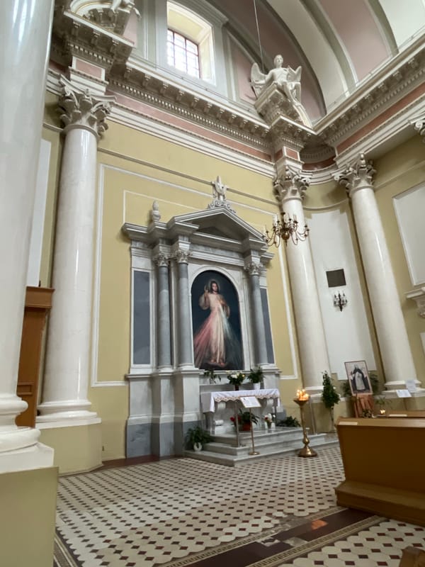 Visitor documents ornate church interior and religious artwork in Saint Petersburg