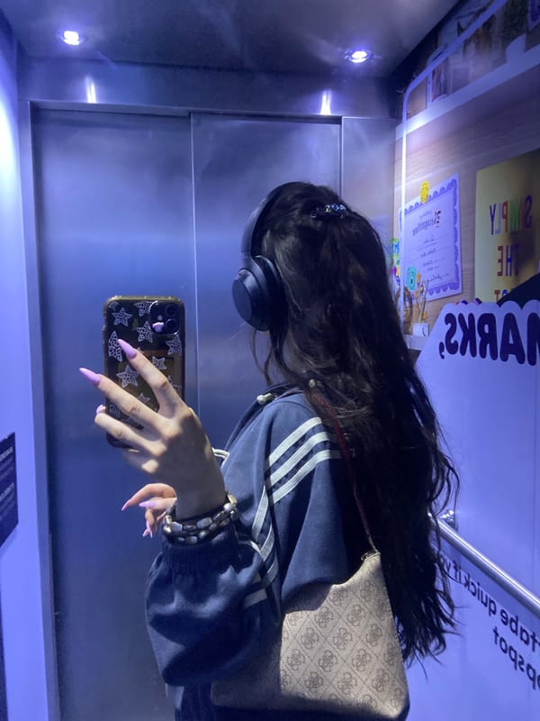 Woman in striped hoodie rides elevator with headphones