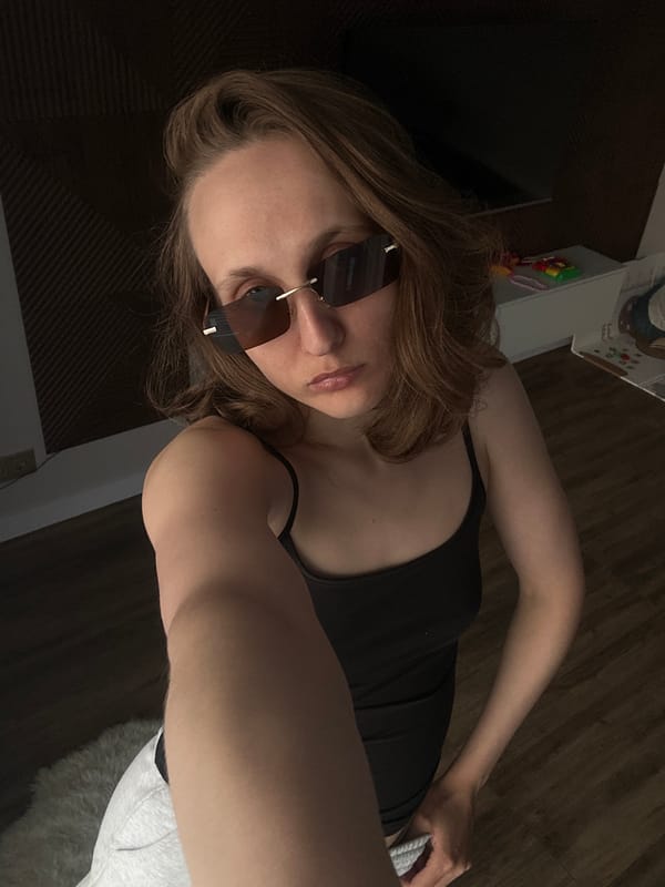 Woman tries on sunglasses indoors in Russian town