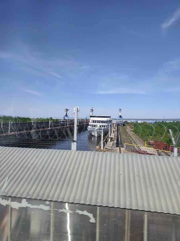 Spring day observations along Chaikovsky waterfront include ship transit