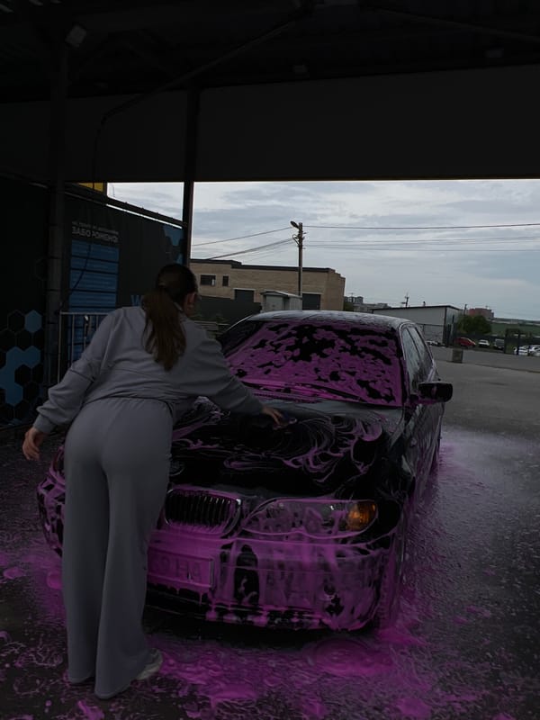 Woman washes BMW with pink foam at Ukrainian car wash