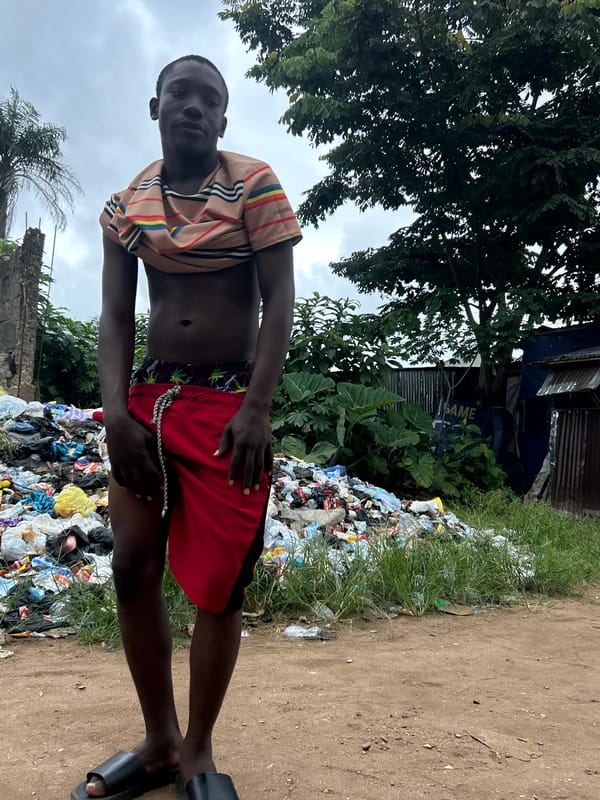 Large garbage mound on a dirt path in Ihiagwa, Nigeria