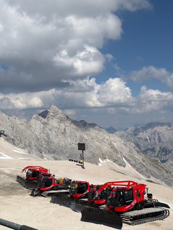 Snow groomers parked high on a Bavarian Alpine slope