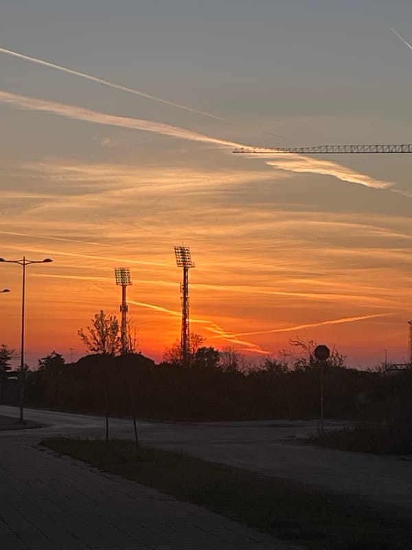Sunset documented across Bar, Montenegro with prominent airplane contrails