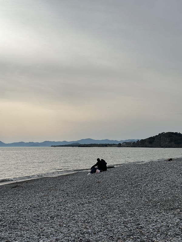 Woman takes selfie at Fethiye beach under overcast skies