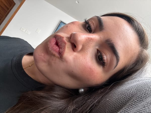 Woman takes selfie while someone uses laptop in Mexico