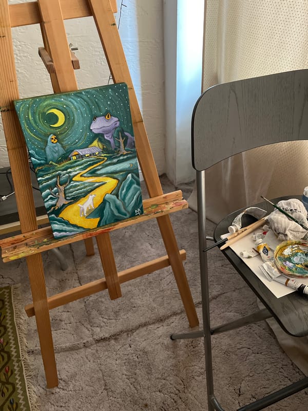 Artist workspace captures mystical landscape painting with glowing elements