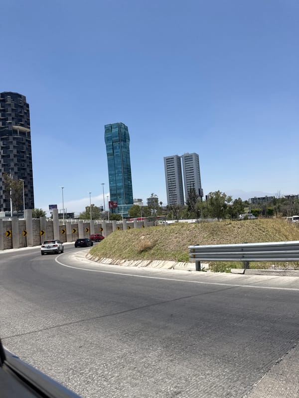Highway travelers document urban skyline in Tlaxcalancingo, Mexico