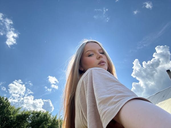 Woman takes selfies under sunny skies in Chaikovsky