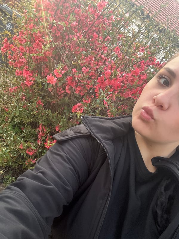 Woman Takes Selfie with Red Flowering Bush in Pleven