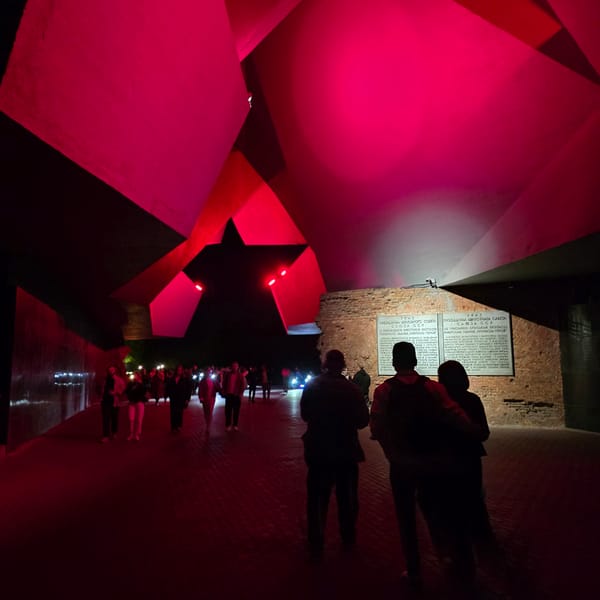 Evening visitors gather at illuminated Brest Fortress red star monument
