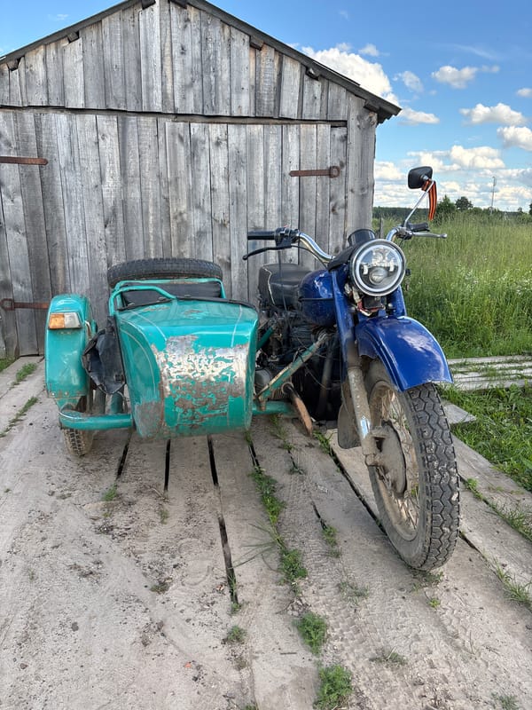 Soviet sidecar motorcycle and wildflowers in rural Kurgan