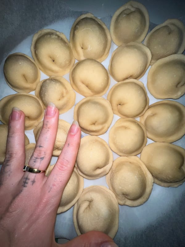 Person prepares homemade dumplings for storage in Belgrade suburb