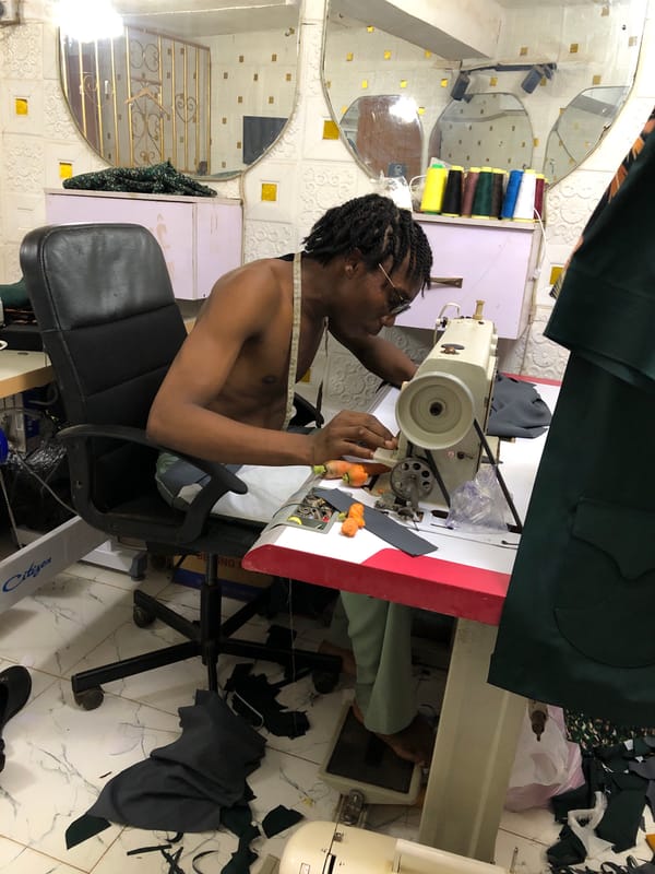Tailor works industrial sewing machine at Onitsha workshop