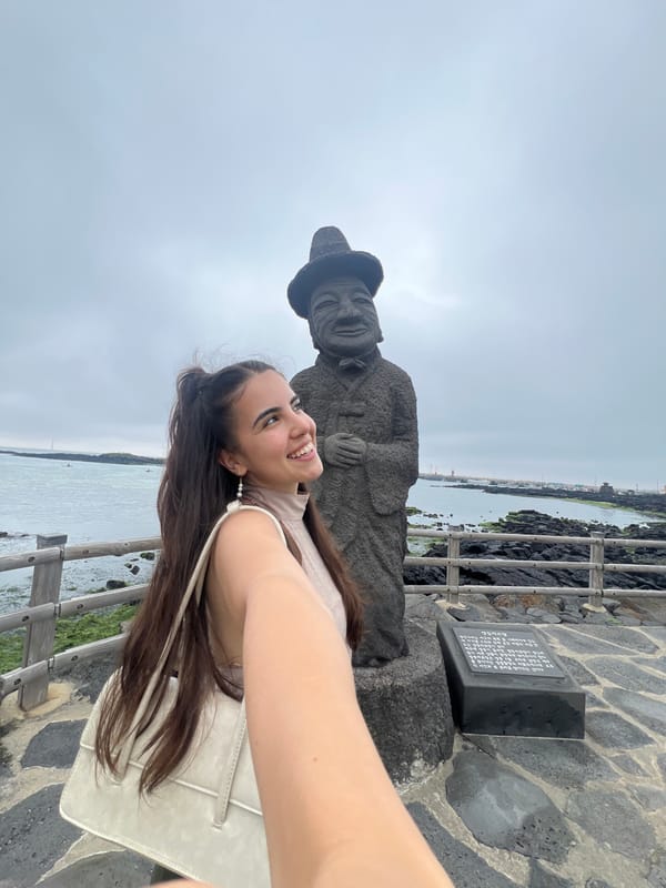 Tourist takes selfies with statue on Jeju Island