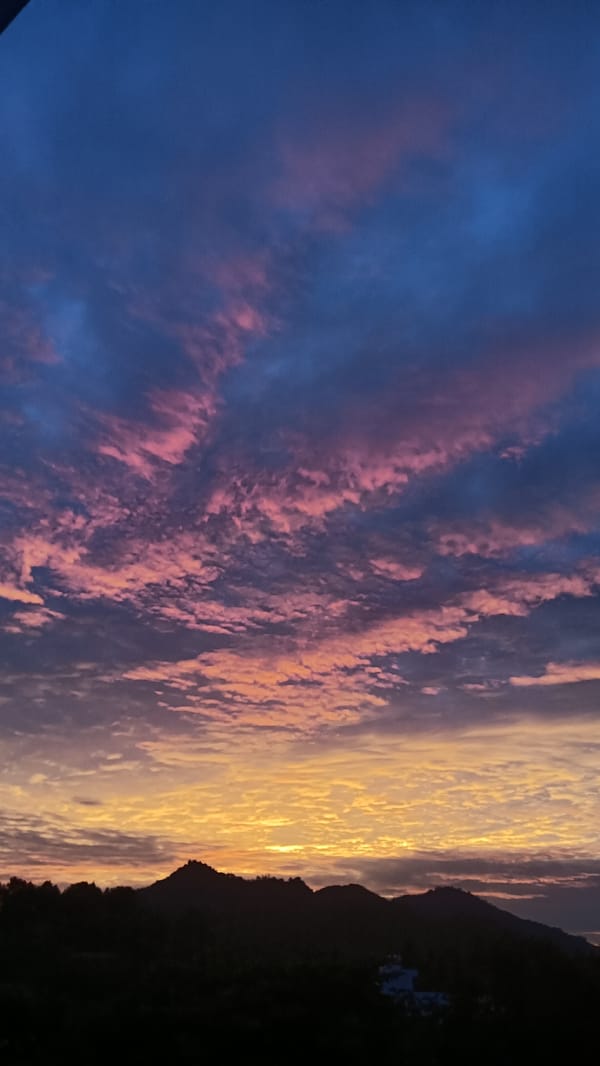 Rooftop sunset watch over Nha Trang's mountain skyline