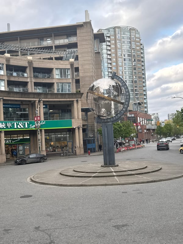 Globe sculpture observed on Vancouver street during cloudy day