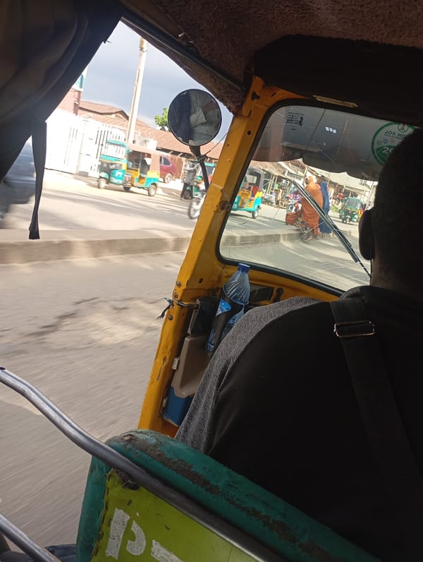 Riding through Jos streets in a yellow auto-rickshaw