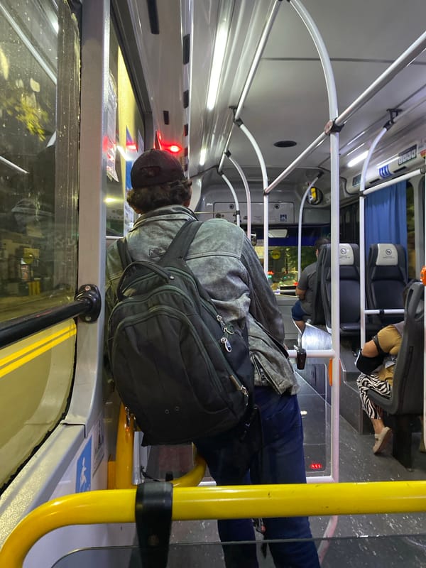 Morning commuter stands on Buenos Aires city bus