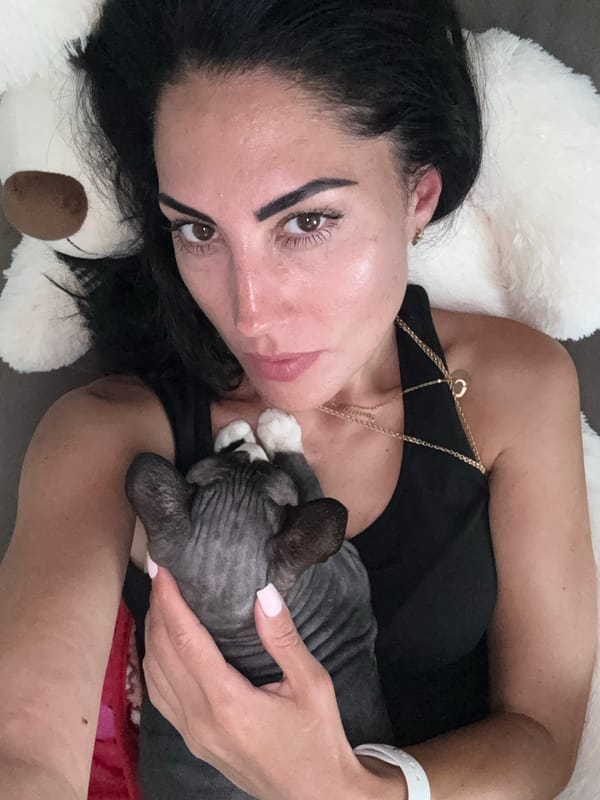 Woman relaxes indoors with Sphynx cat in Netanya