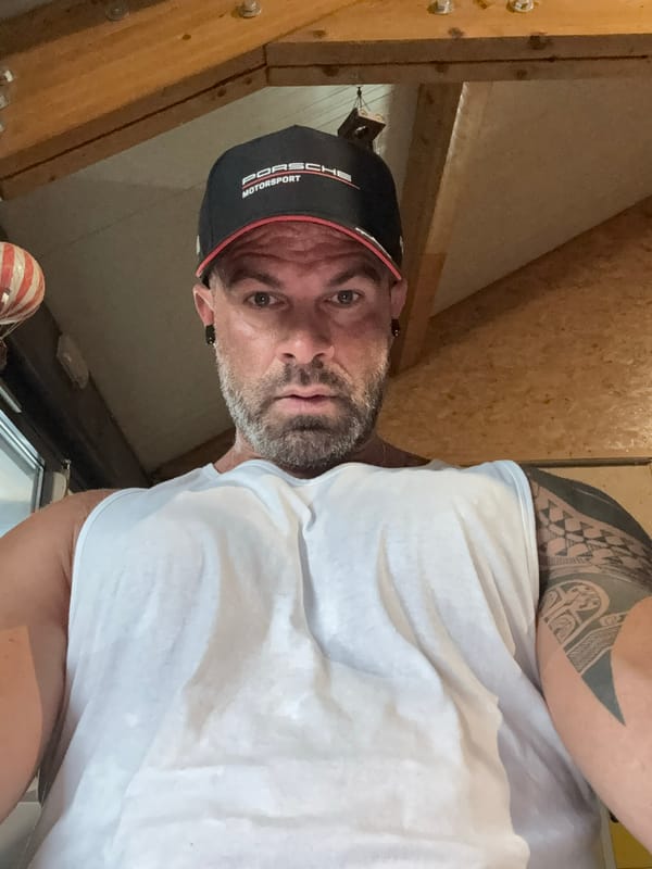 Man in Porsche cap photographed in Belgian attic