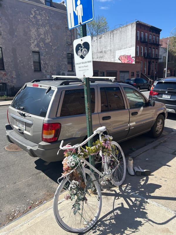 Ghost bike memorial with flowers spotted on NYC sidewalk