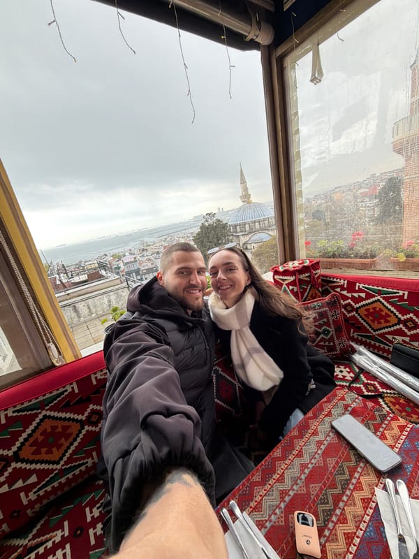 Tourists photograph overcast Istanbul skyline from elevated viewpoint