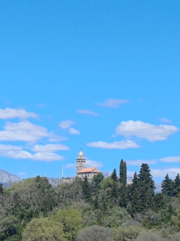 Church tower and balcony views captured in Gošići Montenegro