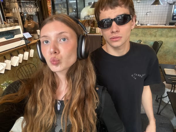 Young couple takes playful selfies at Shanghai cafe