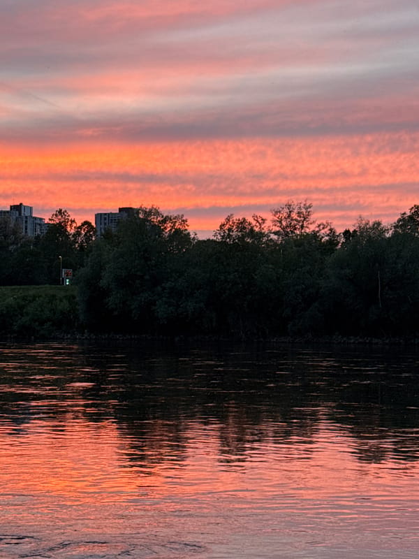 Vibrant sunset over Sava River illuminates Zagreb waterfront