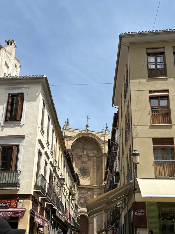 Tourist documents Granada cathedral district during midday stroll