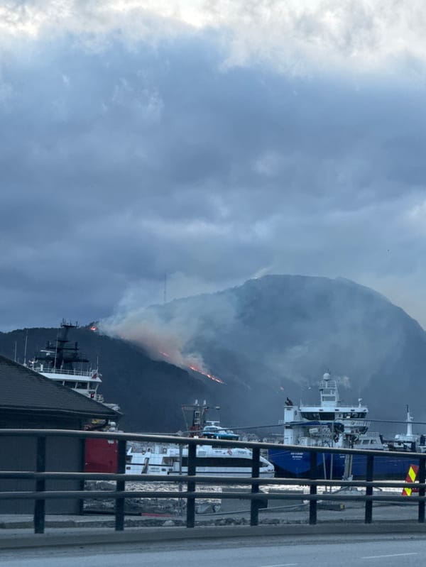 Wildfire burns on mountain overlooking Ålesund, Norway harbor