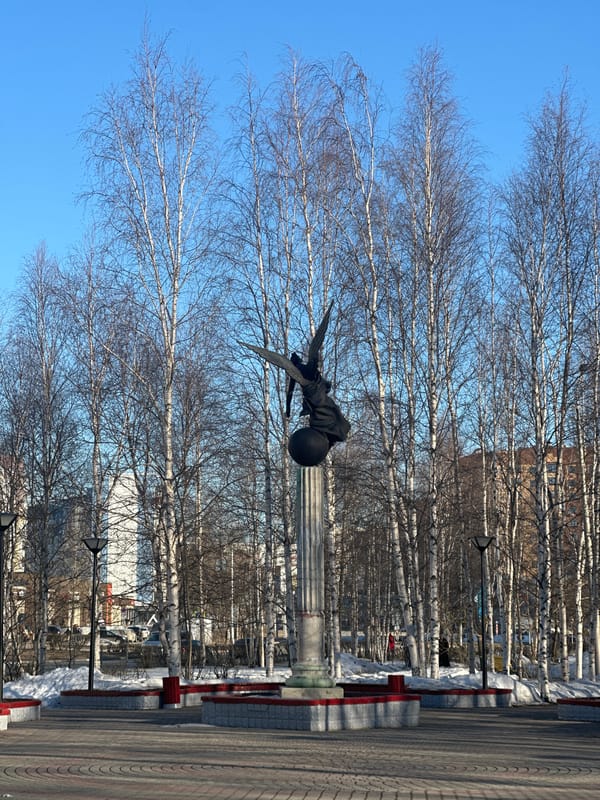 Casual moments captured near winged monument in Surgut, Russia