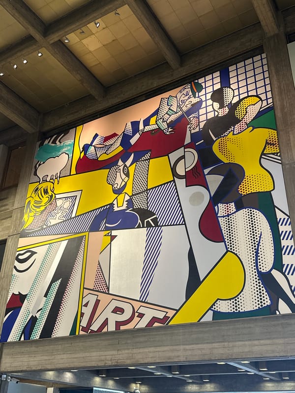 Visitor documents colorful pop-art displays in Tel Aviv building