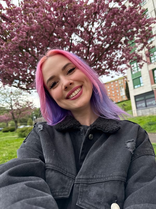 Woman takes selfie by cherry blossoms in Oviedo