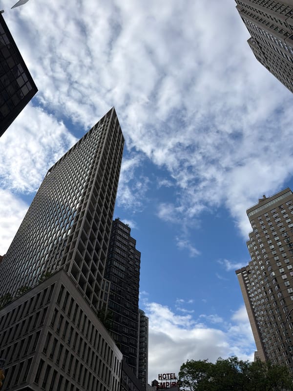 NYC skyscrapers photographed from street level urban canyon perspective