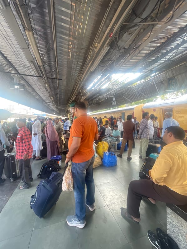 Late-night travelers gather at Mumbai railway station platform