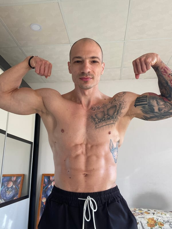 Tattooed man poses flexing indoors in Pleven Bulgaria