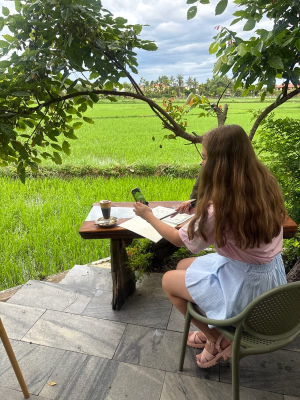 Café dining beside Hoi An's rice paddies on an overcast day